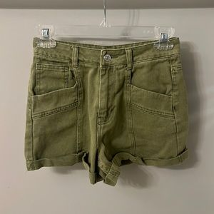 Army green jean shorts with cuffed bottoms.